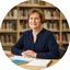 Guest columnist seated at a library table with Coachella Valley notes